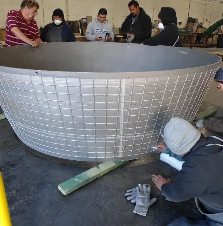 A group of people working on an object.