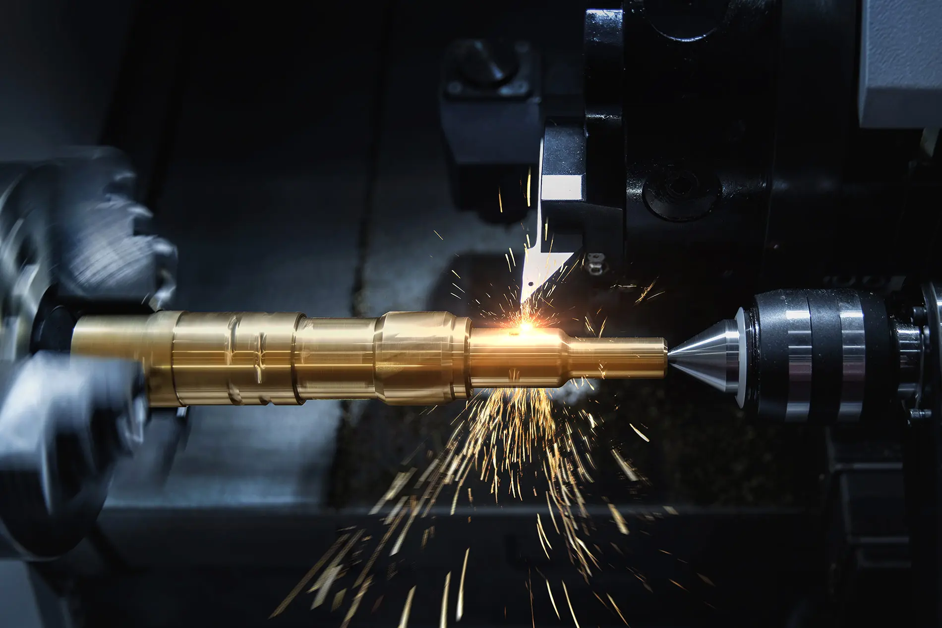 A machine cutting metal with sparks flying from it.